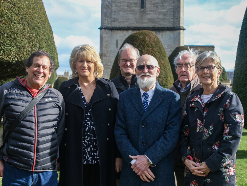 Group photo for launch of Village of the Year 2026 - GRCC staff and Painswick villagers in Painswick churchyard amid famous yew trees